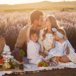 A joyful family picnic in a lavender field, capturing togetherness and love at sunset.